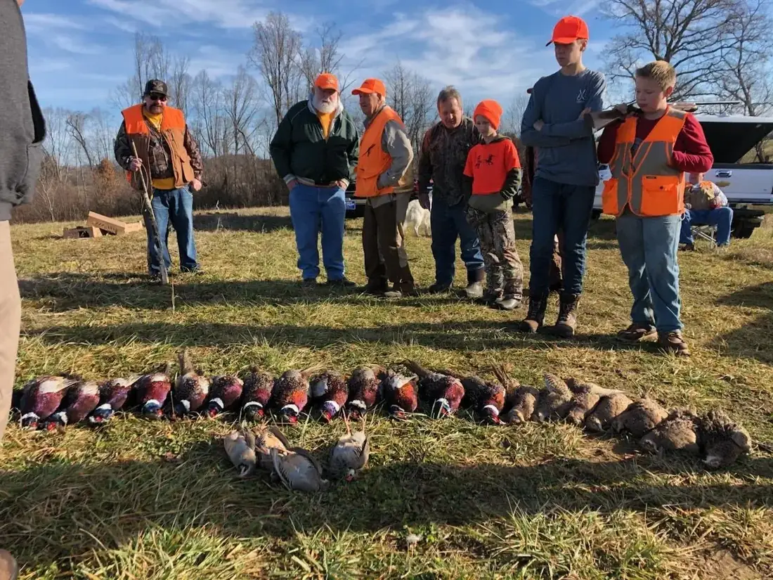 A full party of hunters behind a long row of preserve birds