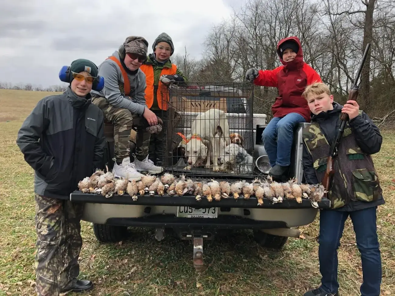 Young hunters on the tailgate with a spread of quail at R&D Adventures