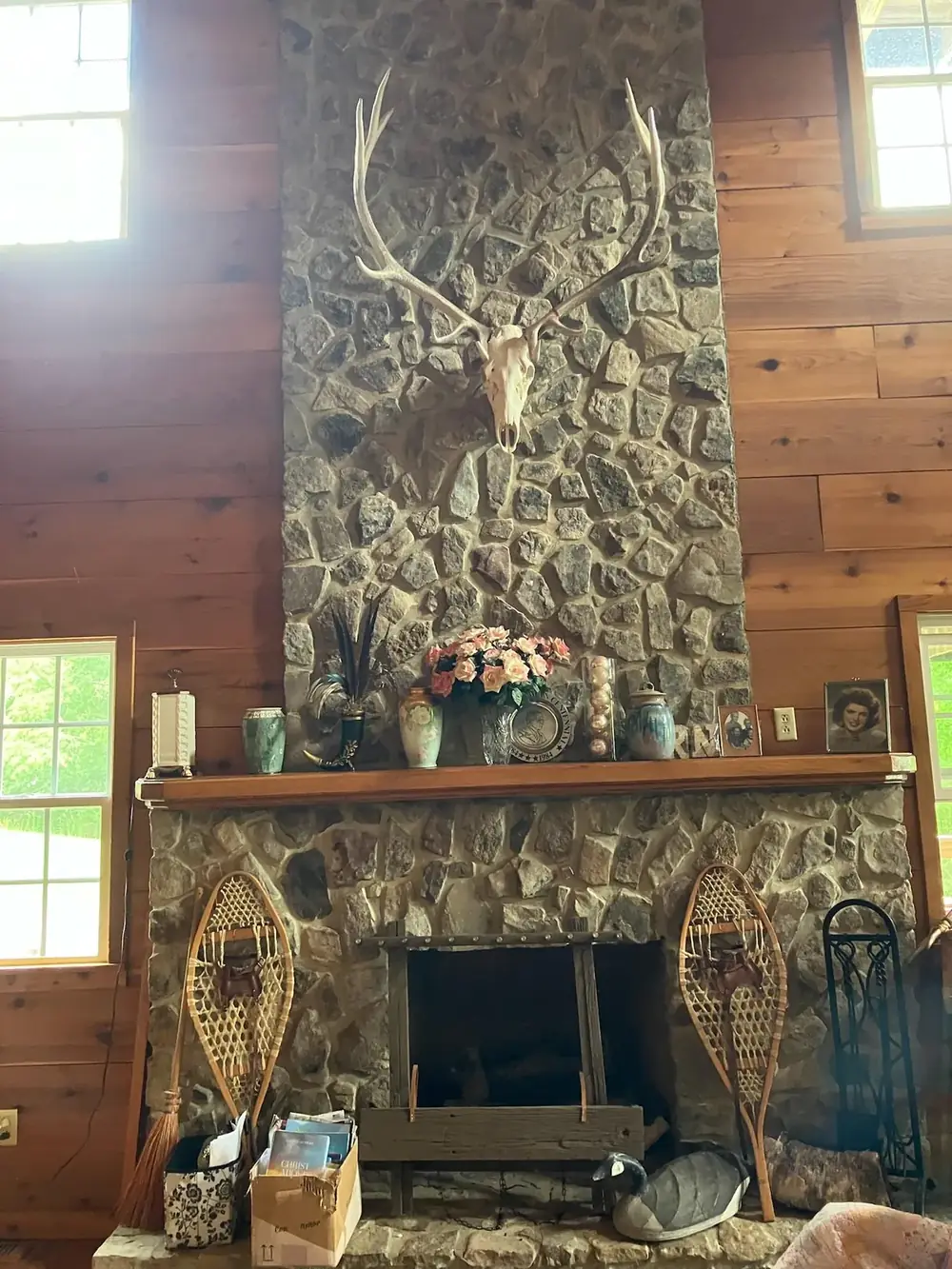 The stone fireplace and mount in the R&D Adventures lodge great room